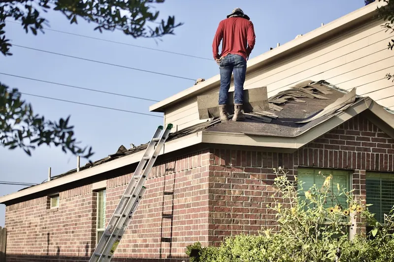 Professional roofer working on a residential roof in Mont Belvieu
